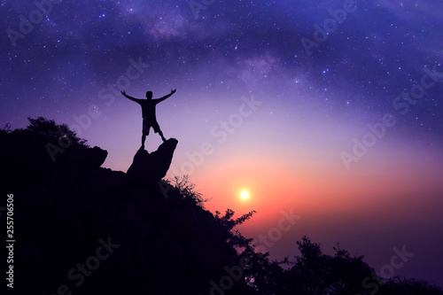 Man standing on the mountain with  million stars galaxy