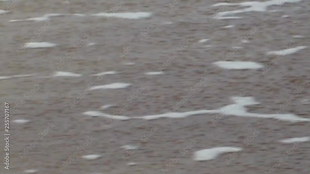 Sand and waves on the sea beach.