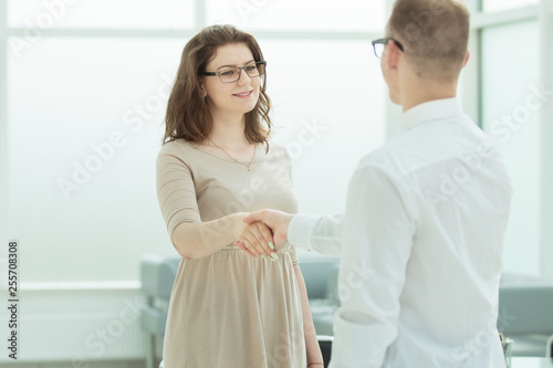 businessman and businesswoman shake hands when meeting in the office