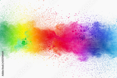 Colorful powder explosion on white background. Pastel color dust particle splashing.