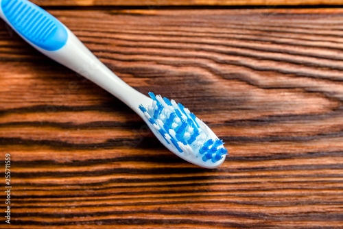 Toothbrush lying on a brown wooden background