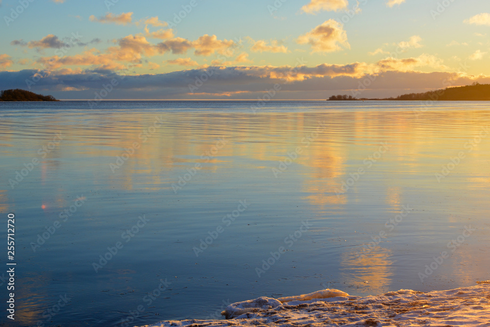 Naklejka premium sunset clouds over lake