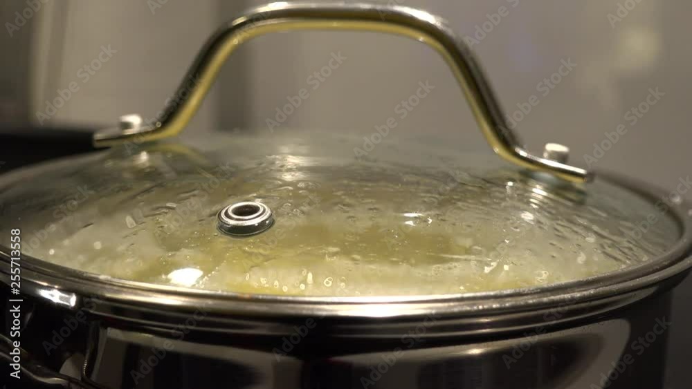 Closeup on a pot of potatoes in boiling water in a kitchen Closeup on a pot of potatoes in boiling water in a kitchen