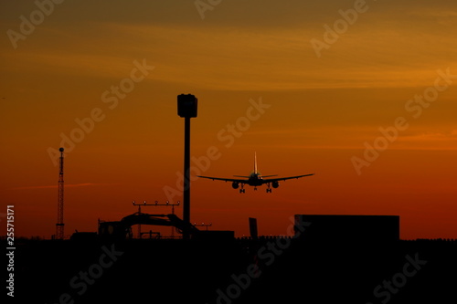 Airplane landing at sunset at Montreal-Trudeau airport, Montreal, Quebec, Canada