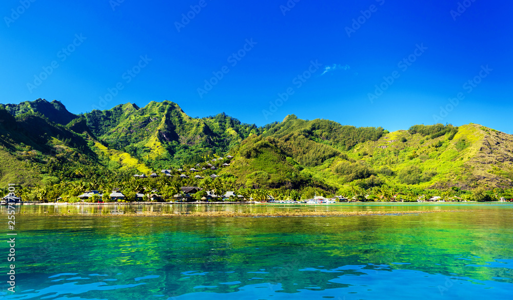 View over turquoise tranquil coral ocean an the mountain landscape, Moorea island, French Polynesia. Copy space for text.