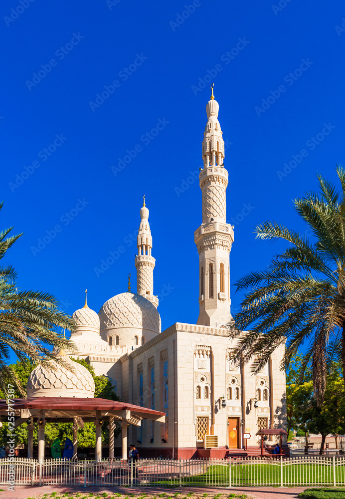 View of the facade of the building of the mosque Jumeirah. Isolated on blue background, Dubai, United Arab Emirates. Vertical.