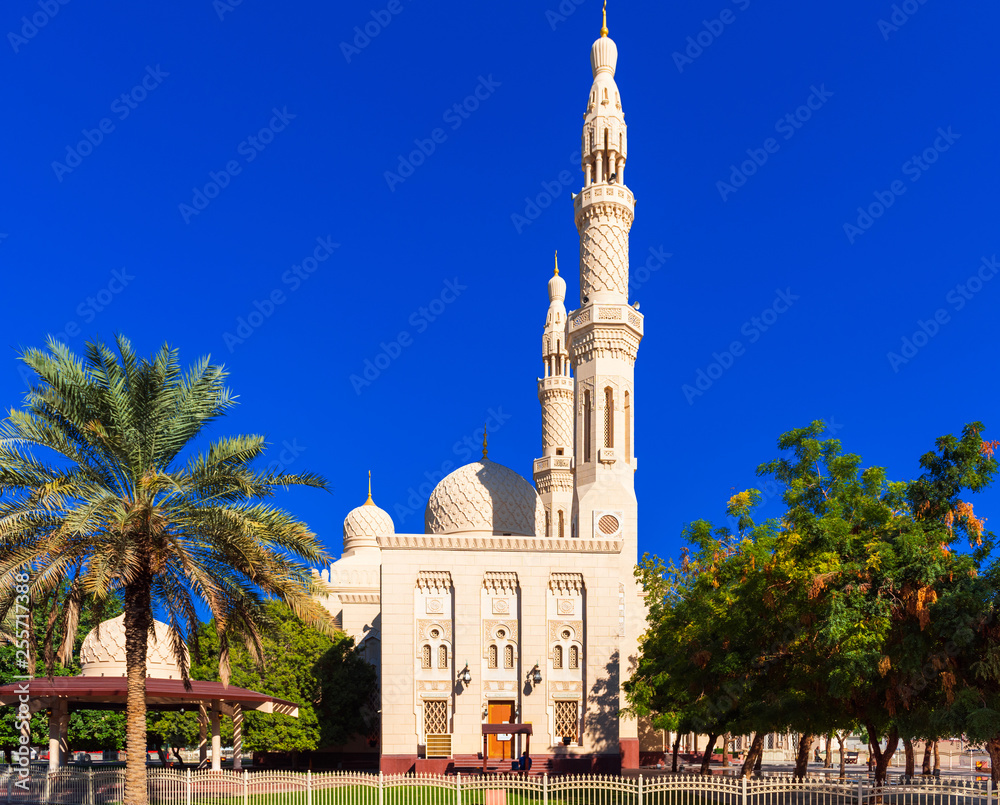 View of the facade of the building of the mosque Jumeirah, Dubai, United Arab Emirates. Isolated on blue background.