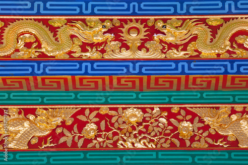 Golden dragon pattern on the wall in the temple.