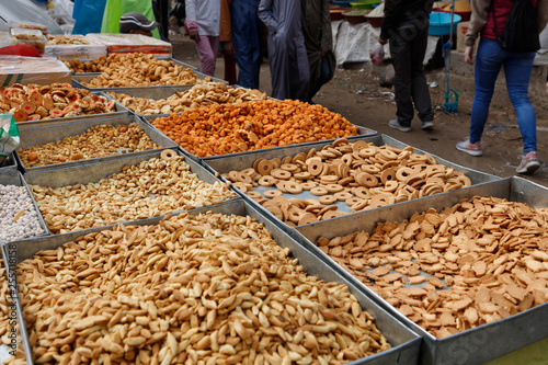 Selection of typical Moroccan nuts, walnuts, roasted almonds and other sweets being sold on a local farmer's market in the Atlas mountains (Morocco, Africa)