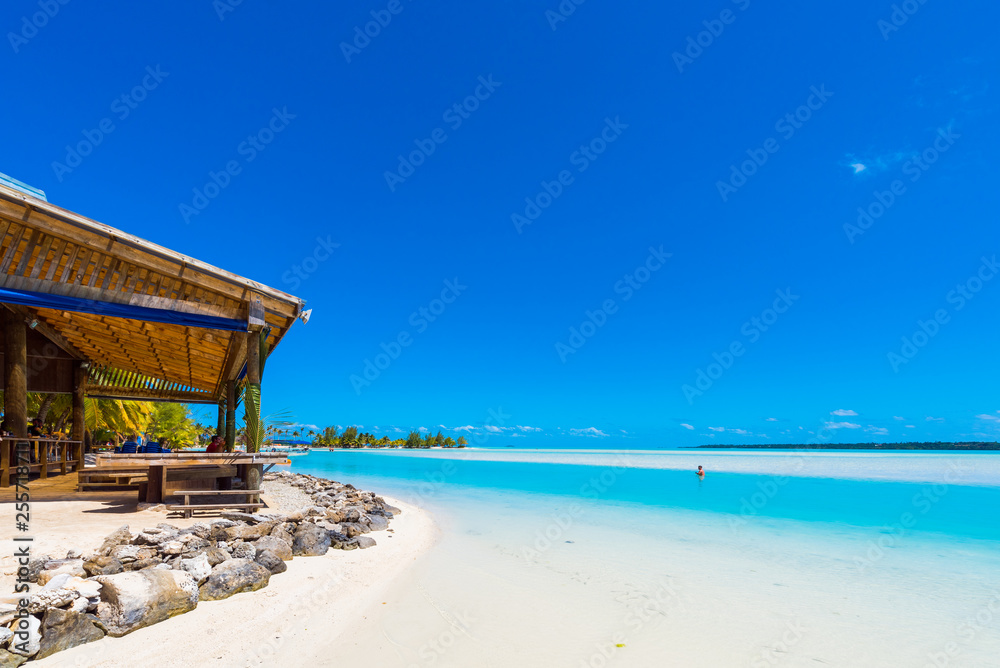 View of the sandy beach with a sandbank, Aitutaki island, Cook Islands, South Pacific. Copy space for text.