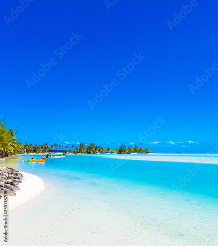 View of the sandy beach with a sandbank, Aitutaki island, Cook Islands, South Pacific. Copy space for text. ..