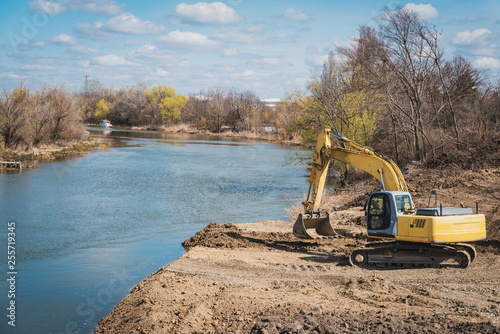 a large dredger prepares the land for the construction of a bridge