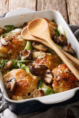 Easy smothered chicken with bok choy and mushrooms close-up. Vertical