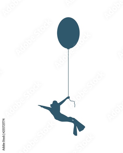 The young man in diver suit flying with toy balloon