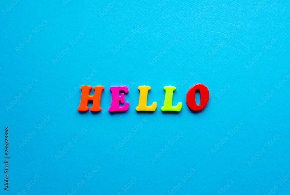 word hello from plastic magnetic letters on blue background word hello from plastic magnetic letters on blue background