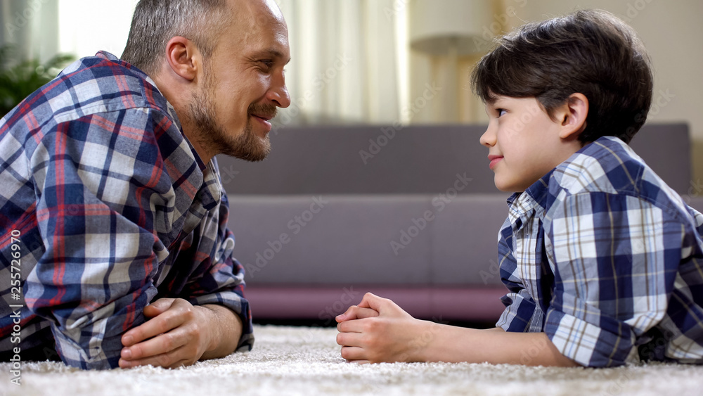 Caring dad praising his little son, fathers care and support, time together Caring dad praising his little son, fathers care and support, time together