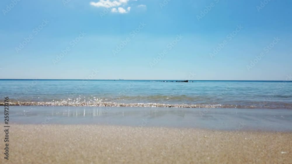 Waves with sand beach under blue sky Waves with sand beach under blue sky