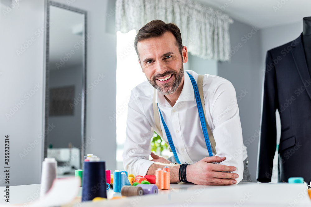 Tailor shop owner over work desk, craftsman in sewing workshop Tailor shop owner over work desk, craftsman in sewing workshop