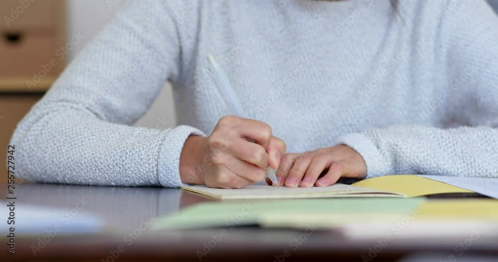 Woman write on note book at home