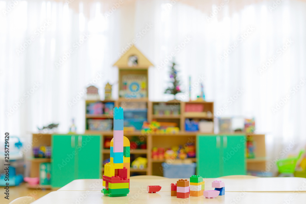 children's toys are scattered on the table in the kindergarten playroom