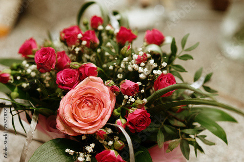  a bouquet of small roses and a large.  holiday gift. selective focus