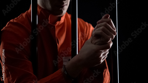 Quadro su tela Inmate in handcuffs rubbing wrists, inhuman conditions and tortures in prison