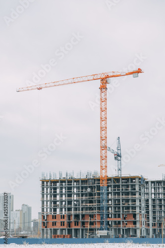 Construction of modern high-rise buildings. Cranes and machinery