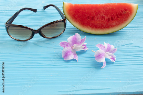 summer concept watermelon and glasses on blue wood