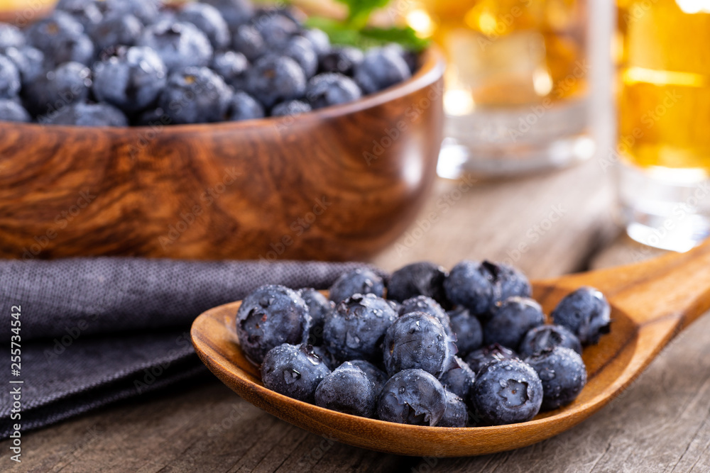 Closeup of a Wooden Spoonful of Fresh Blueberries Closeup of a Wooden Spoonful of Fresh Blueberries