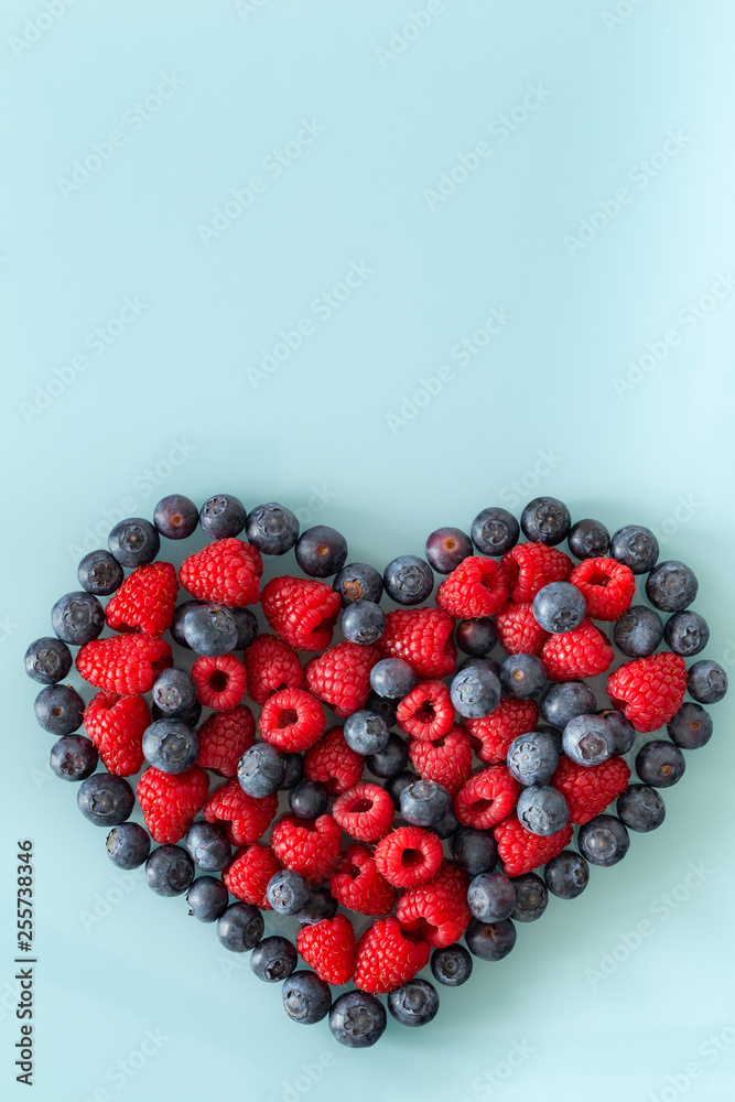 Forest fruit, raspberries and berries arranged in the shape of a heart with place for a text Forest fruit, raspberries and berries arranged in the shape of a heart with place for a text