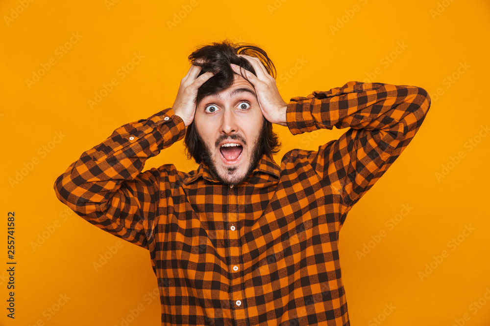 Portrait of european man grabbing head and shouting while standing isolated Portrait of european man grabbing head and shouting while standing isolated
