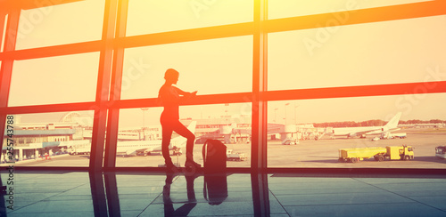 traveler at airport. silhouette of a girl with a backpack. business and travel