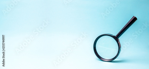 Konstfotografi Magnifying glass on blue background