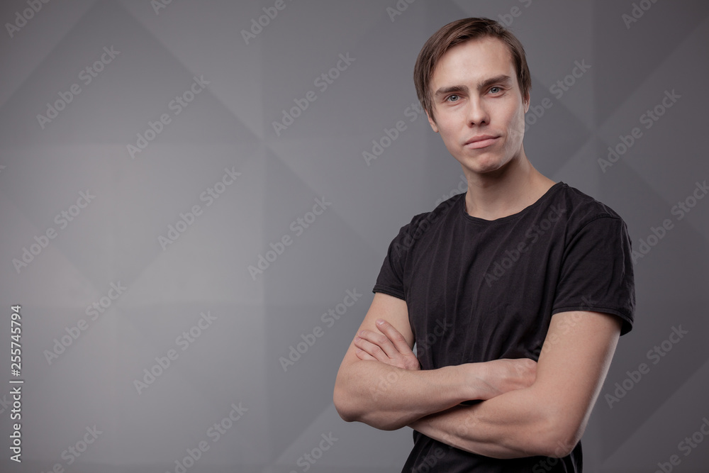 White young man in a black T-shirt and jeans. Emotion. White young man in a black T-shirt and jeans. Emotion.