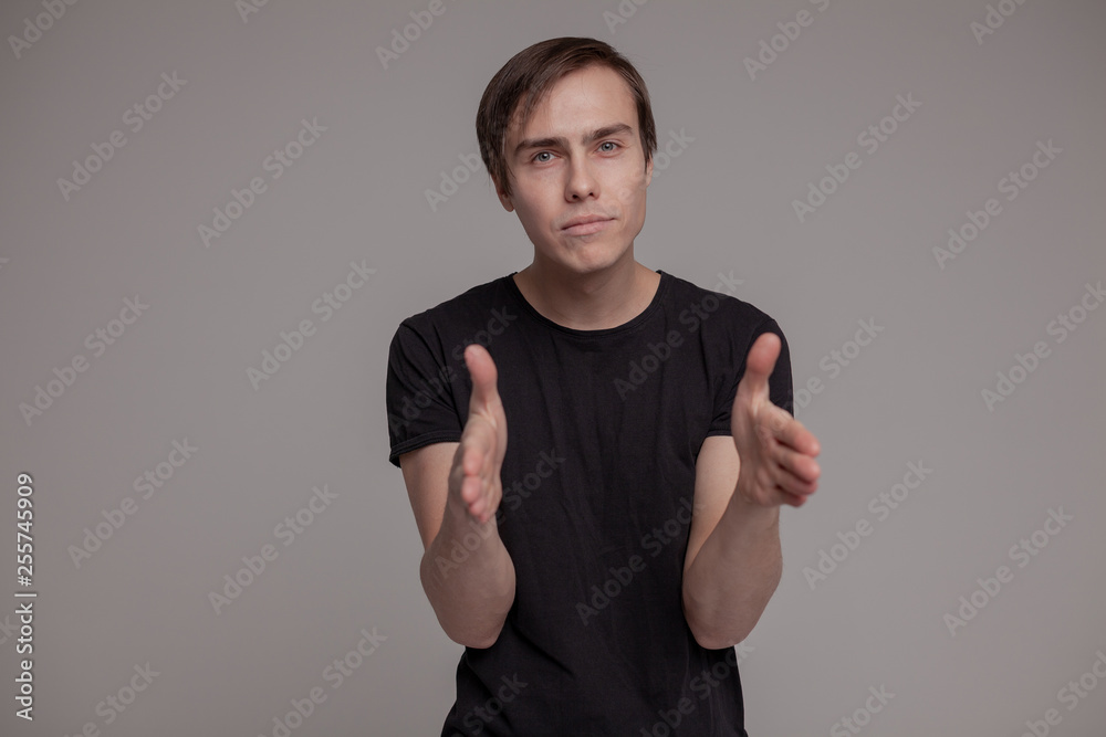 White young man in a black T-shirt and jeans. Emotion. White young man in a black T-shirt and jeans. Emotion.