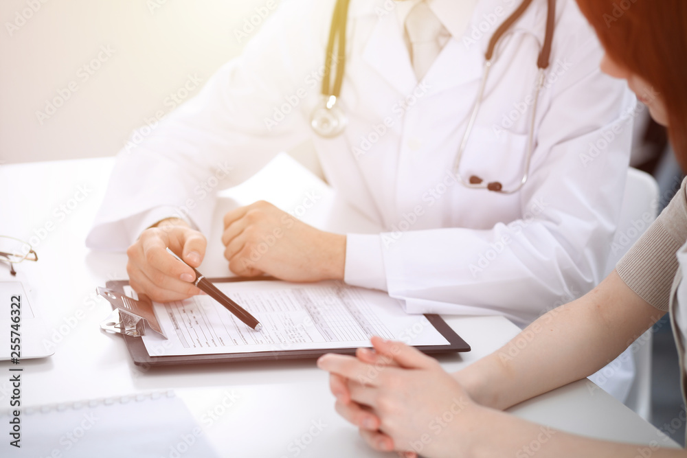 Doctor man and patient are discussing something, just hands at the table. Medicine and health care concepts Doctor man and patient are discussing something, just hands at the table. Medicine and health care concepts