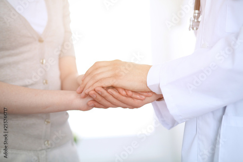 Hand of doctor reassuring her female patient. Medicine and health care concept © rogerphoto