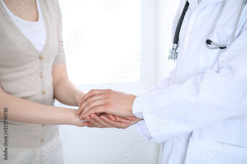Hand of doctor reassuring her female patient. Medicine and health care concept © rogerphoto