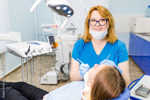 Female dentist treats teeth of the girl