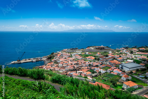 The village of Corvo on the island of Corvo in the Atlantic ocean. Flores island of the Azores in the background. photo