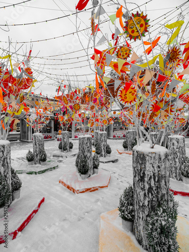 Decorated Christmas trees in honor of the Shrovetide week in Moscow near the red square. Beautiful scenery from colored ribbons, bagels, and rag dolls photo