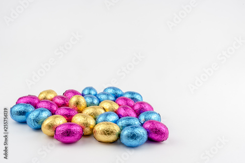 Group of easter eggs in blue, yellow and pink