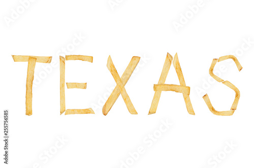 Word TEXAS laid out of long sticks of fried french fries isolated on white background