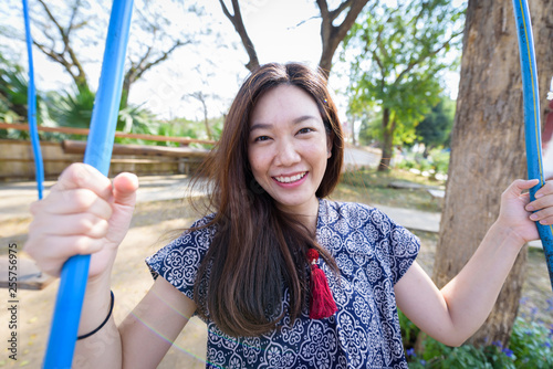 Asian beautiful girl has playing a swing with nature background in the morming at Nan province, Thailand. photo