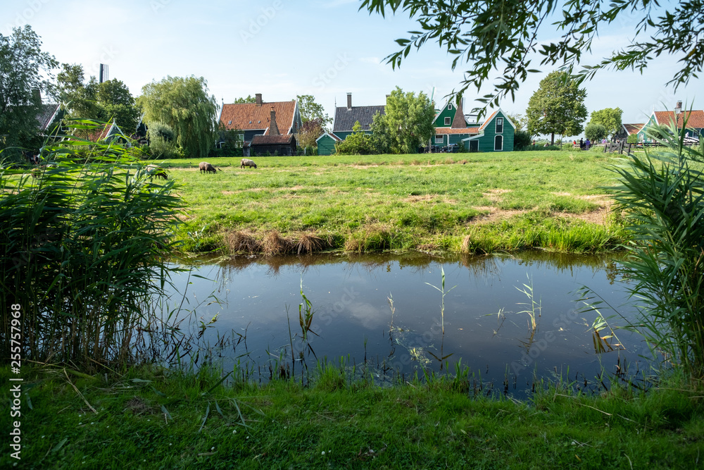 landscape with house, water and trees