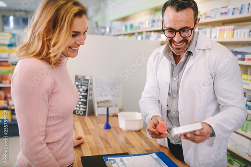 Pharmacist suggesting medical drug to buyer