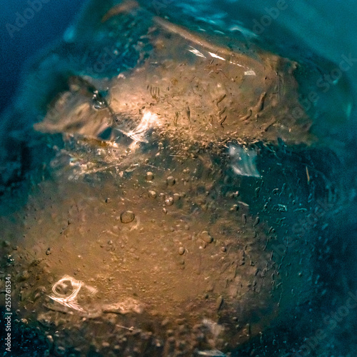 ice cubes in a glass of blue alcohol
