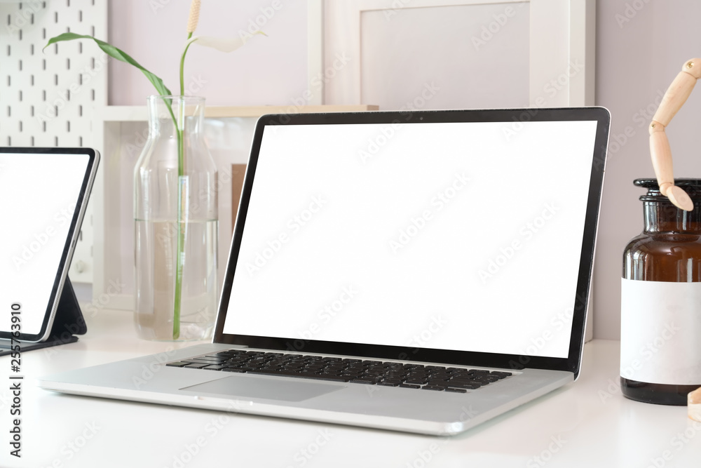 Stylish workspace with blank screen laptop computer and office supplies Stylish workspace with blank screen laptop computer and office supplies