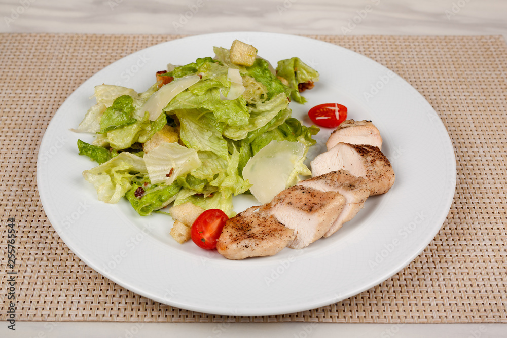 Stewed chicken fillet with tomato and cabbage salad. Stewed chicken fillet with tomato and cabbage salad.
