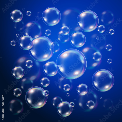 Transparent bubbles over dark blue